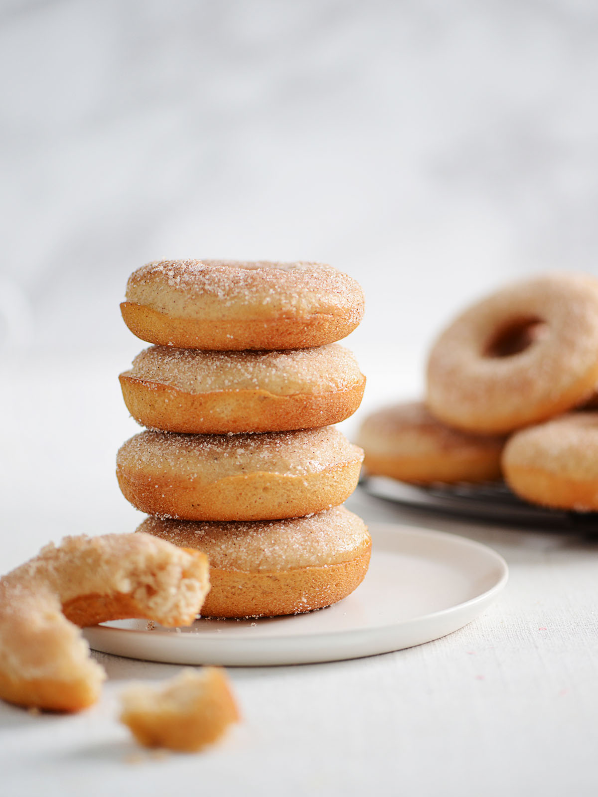 A stack of donuts placed on a plate.