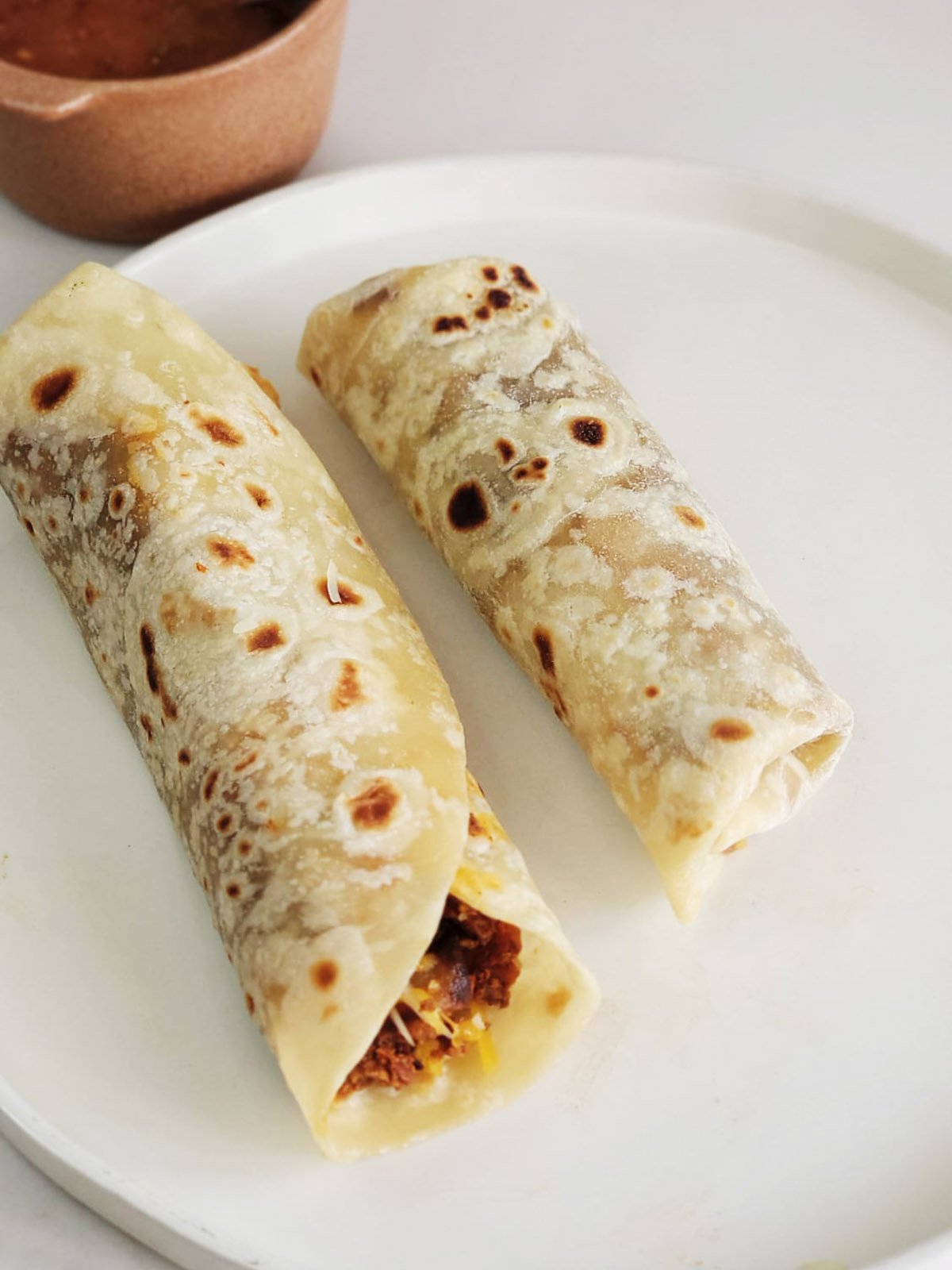 Two burritos side by side.