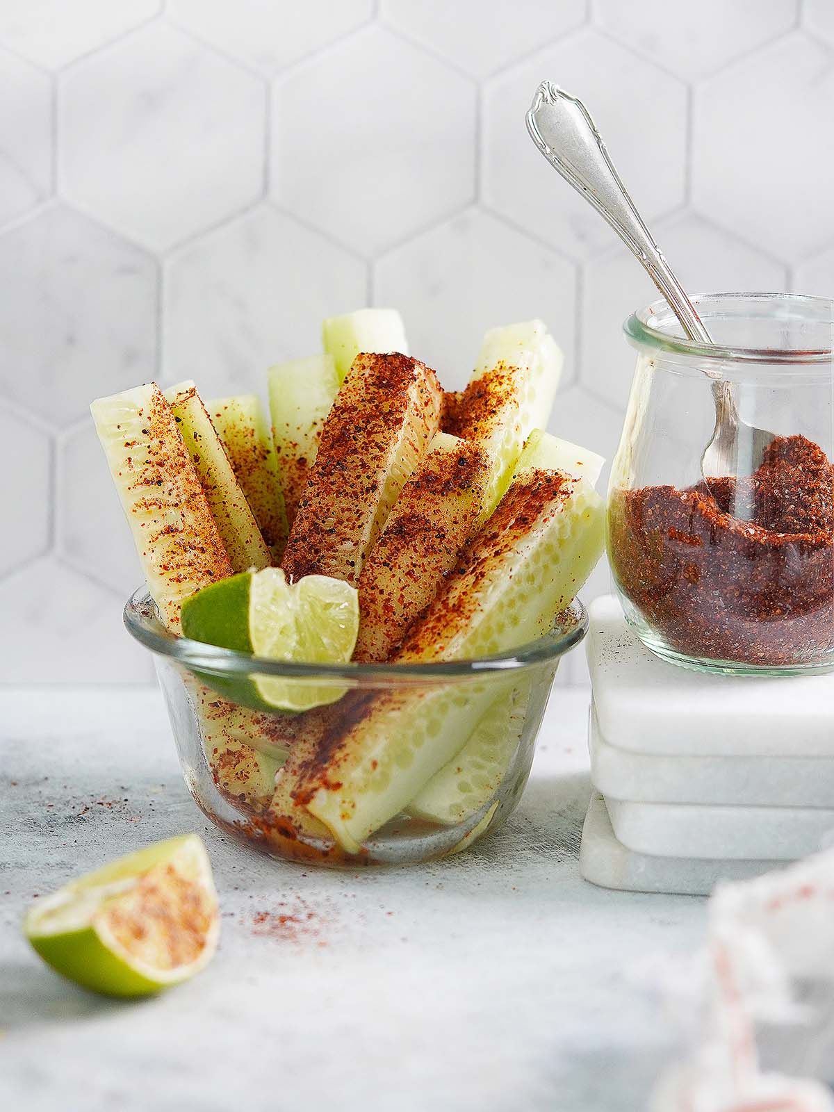 A cup with cucumber slices sprinkled with chili seasoning.