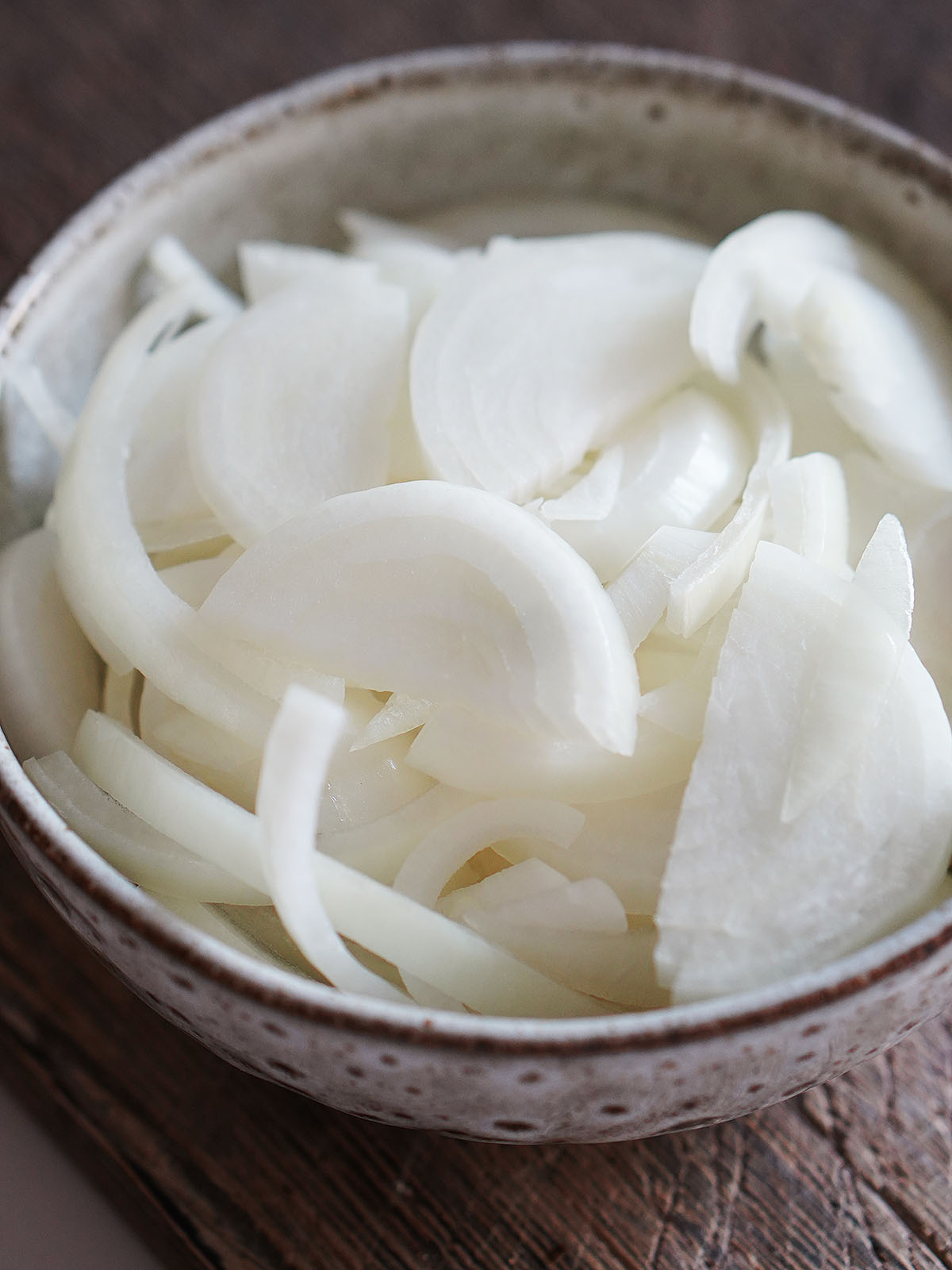 Sliced onions in a bowl.