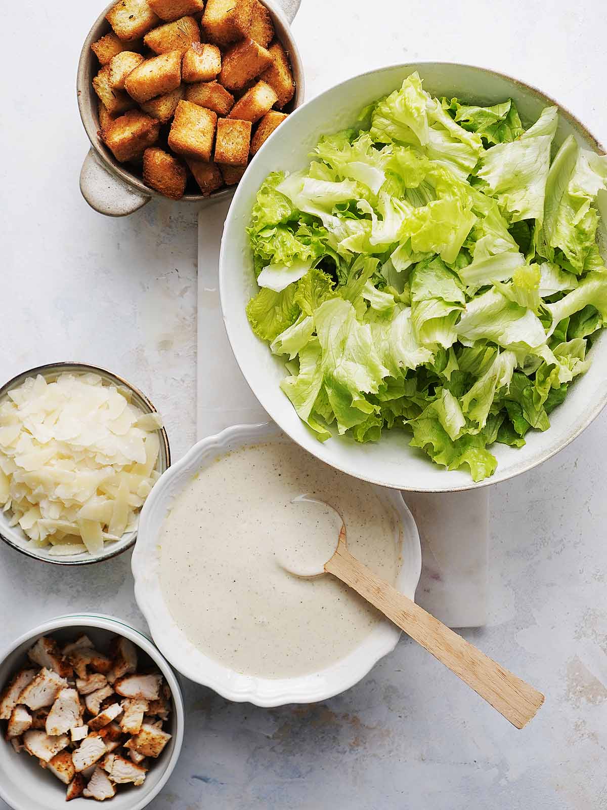All of ingredients for the salad in separate bowls.