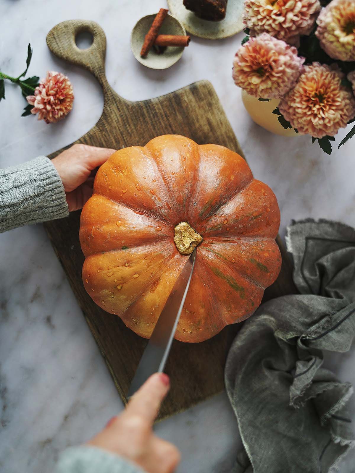 Cutting a pumpkin with a knife.
