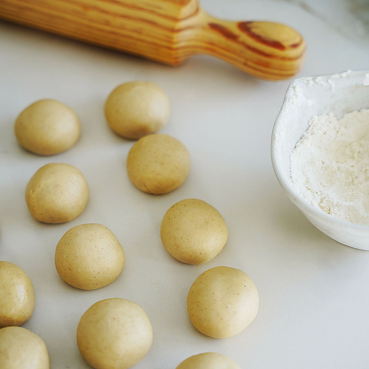 The dough in balls with flour on the side.