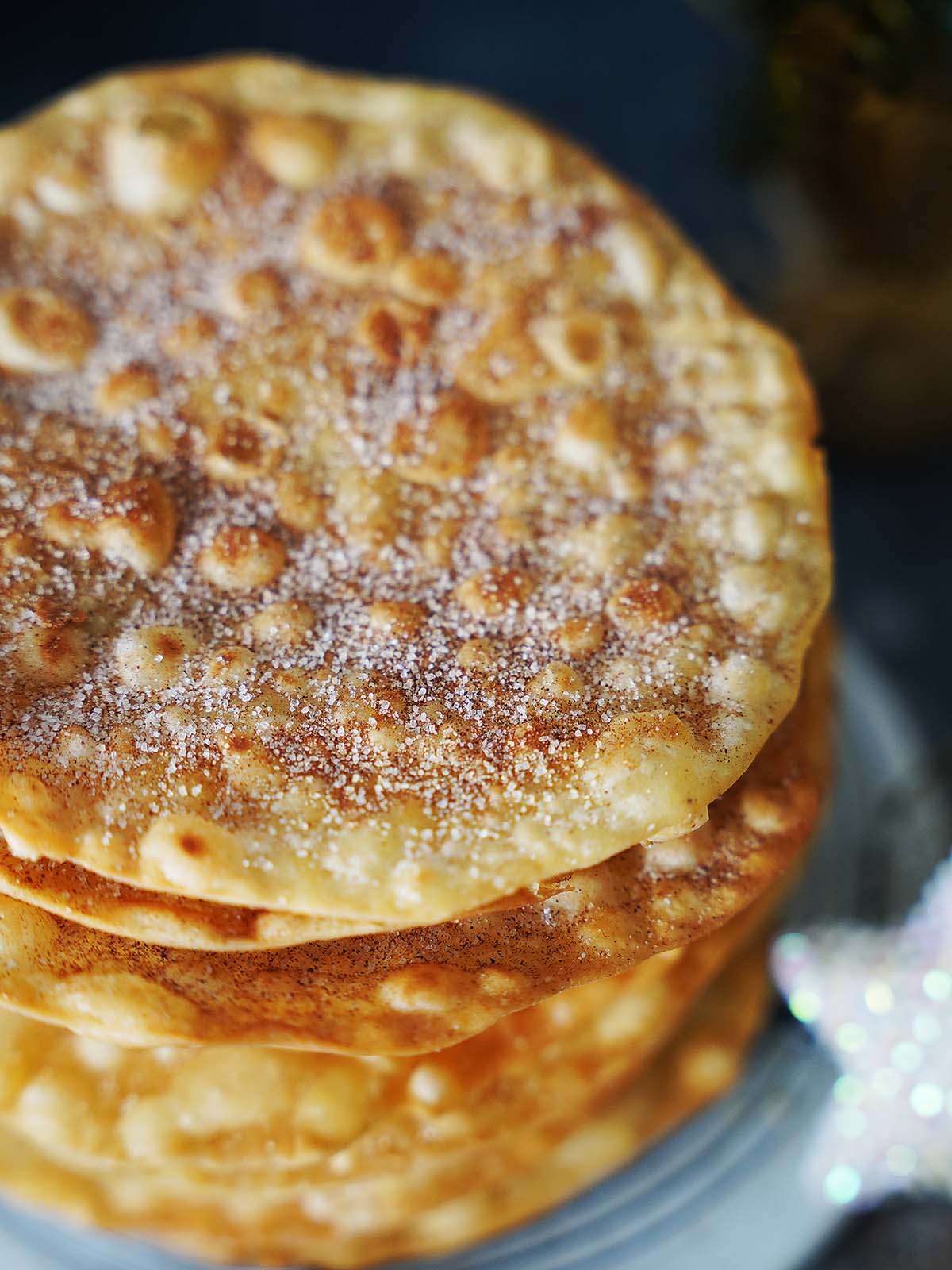 A stack of buñuelos on a white plate.