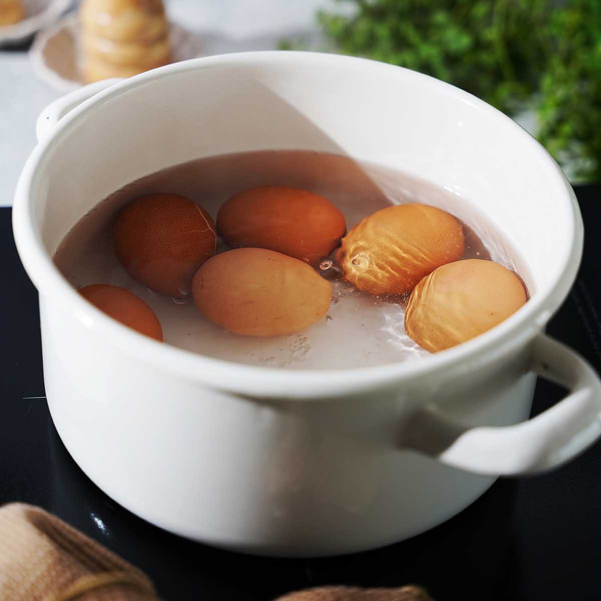 6 eggs boiling in water.