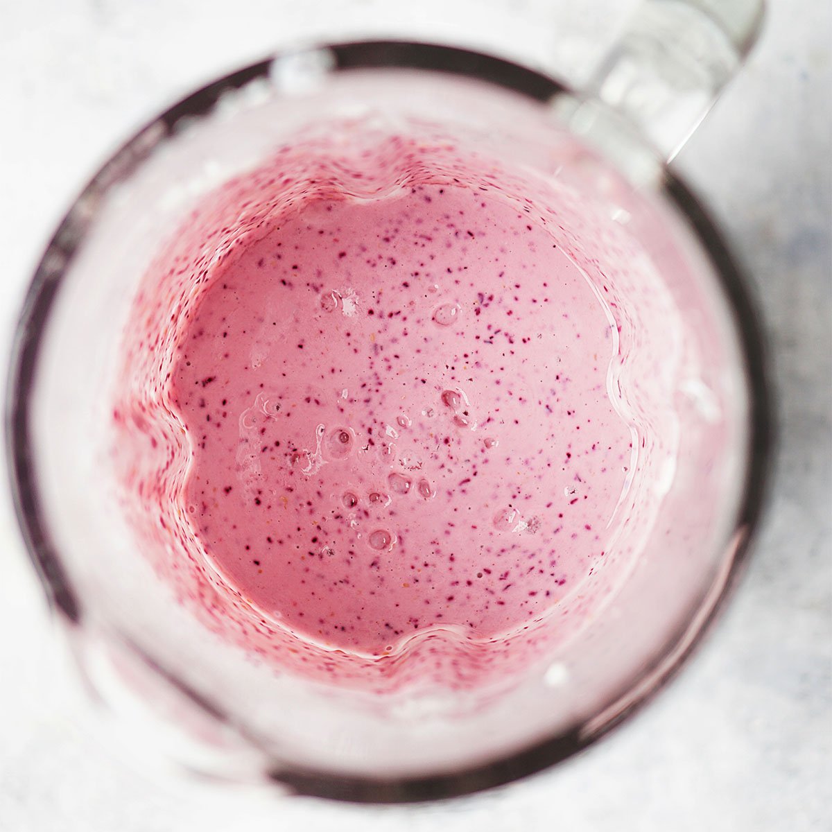Mixed berry yogurt in a blender.