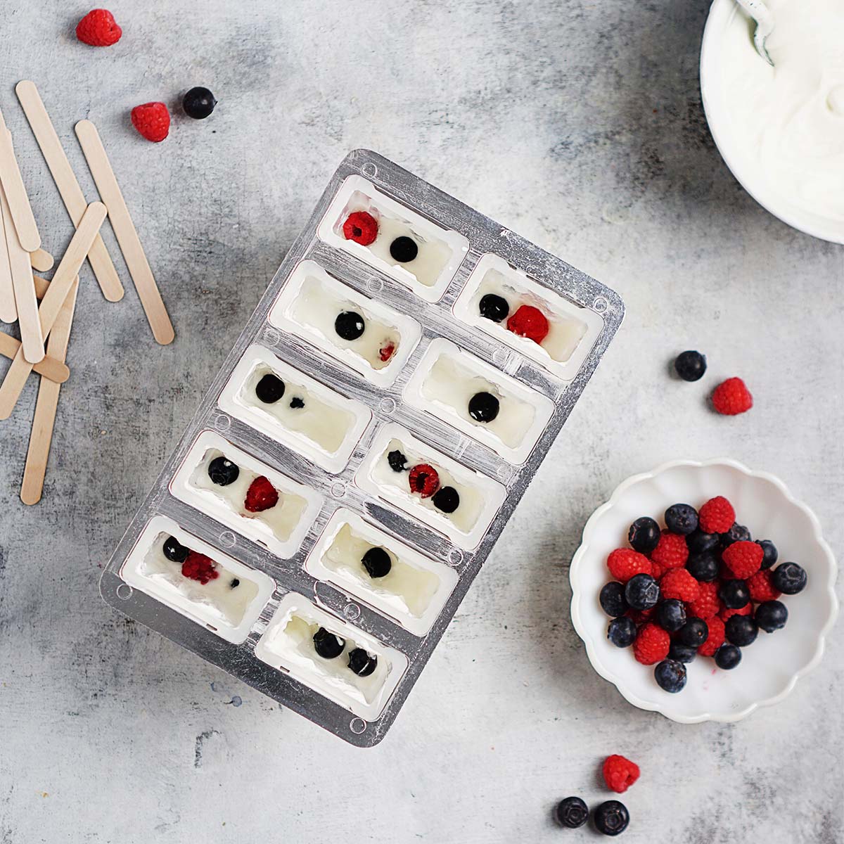Mix on popsicle molds with berries.