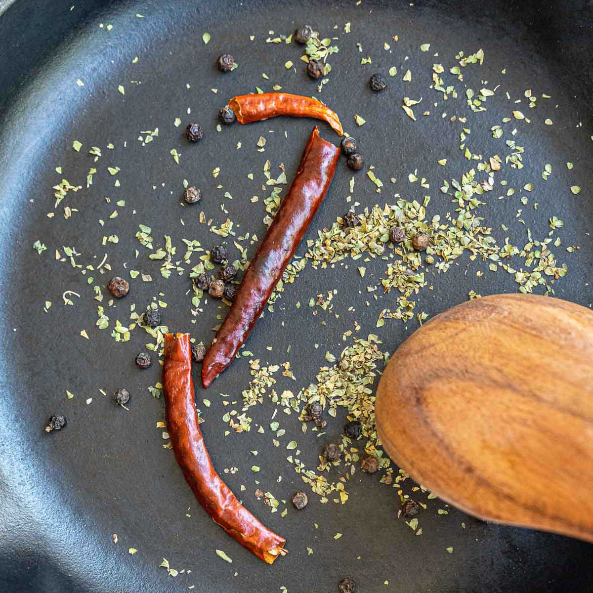 Sauteing the spices in a skillet.