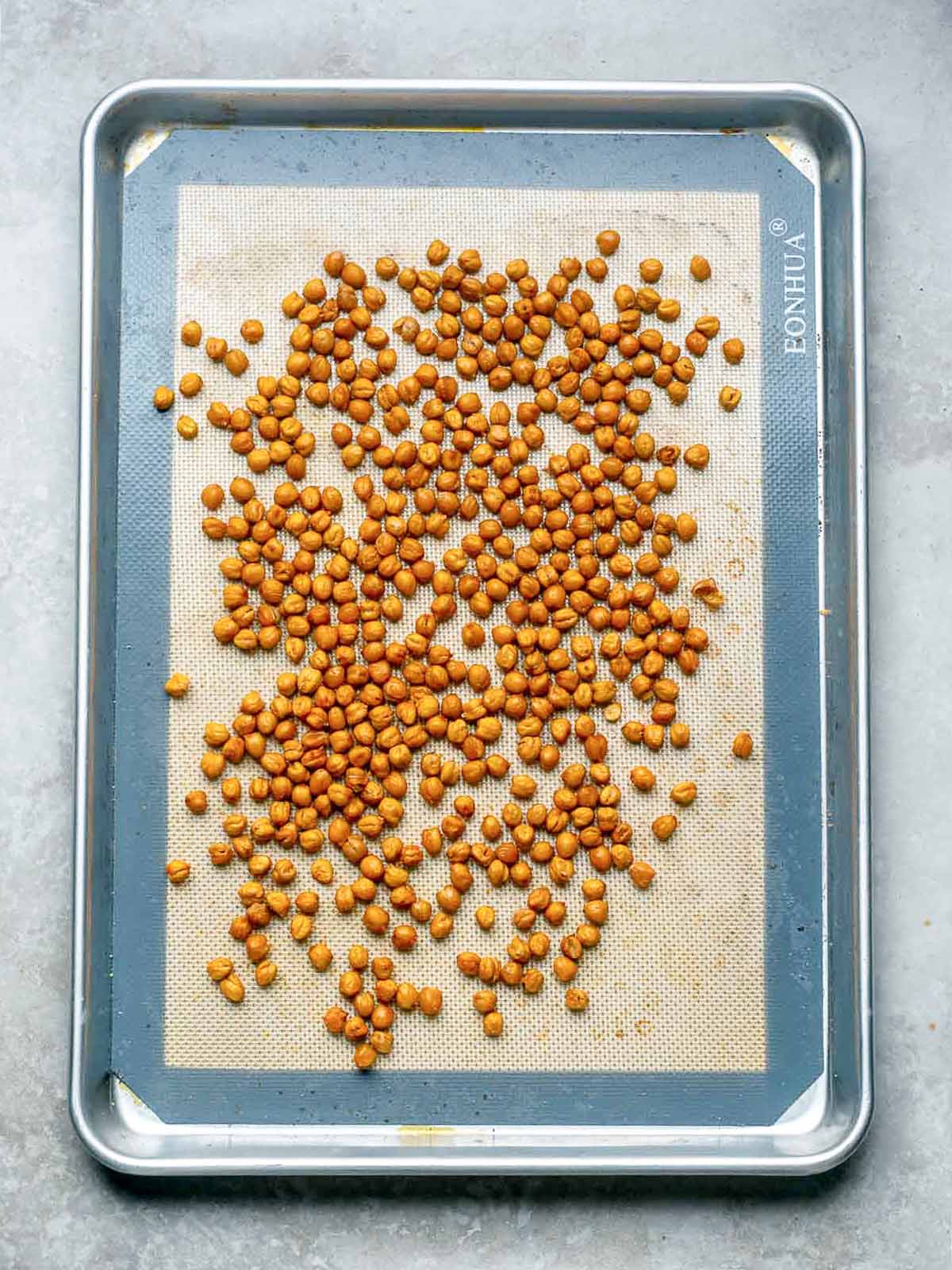 Roasted chickpeas on a baking tray.