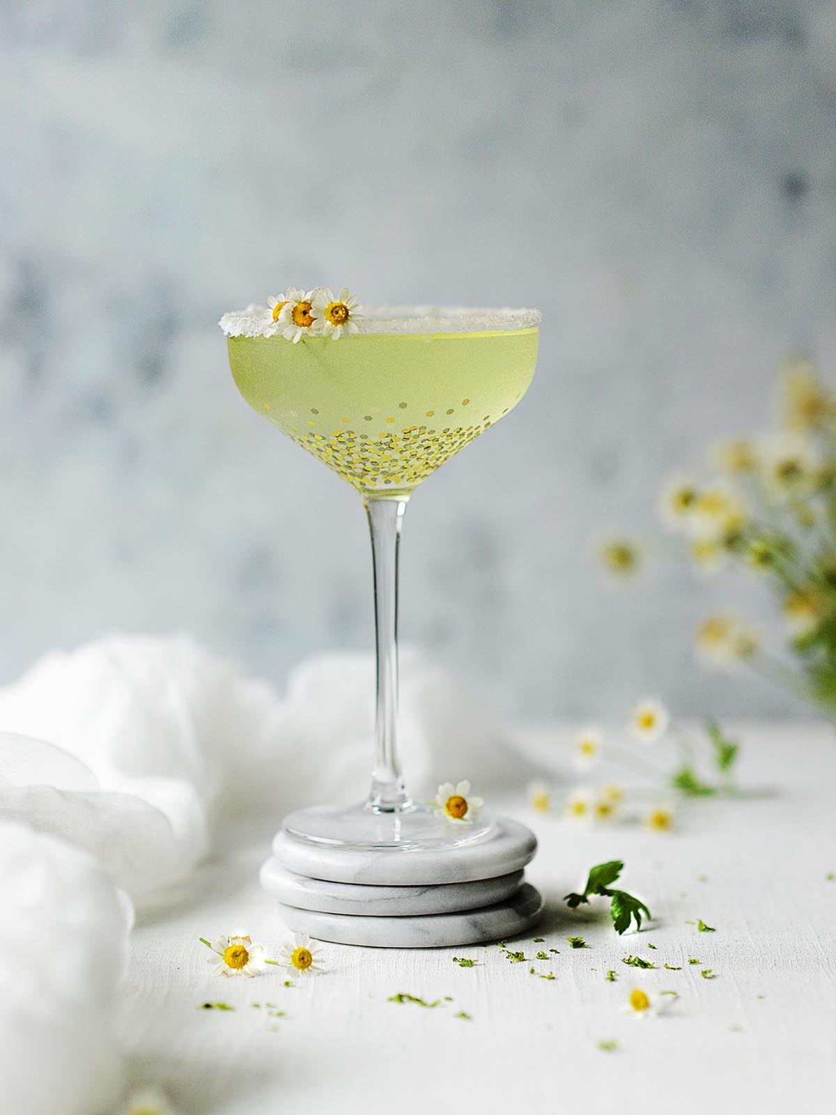 A cocktail glass with Chamomile Tequila Sour.