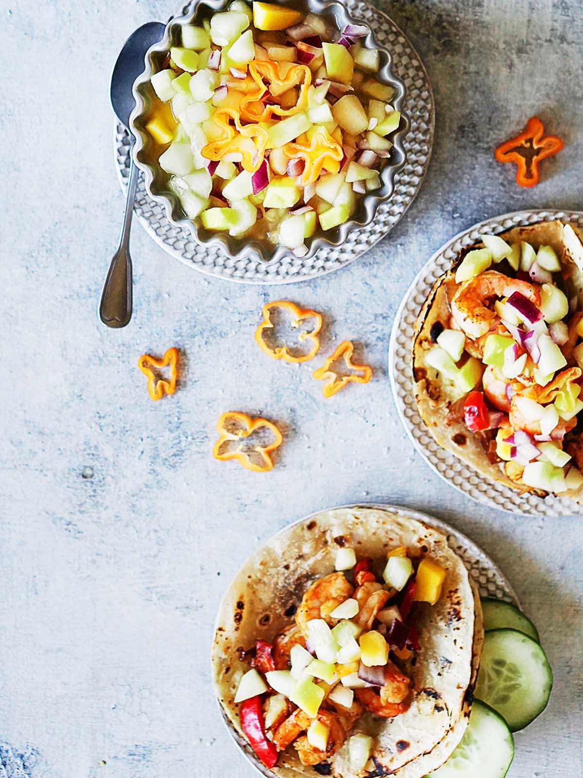 Two tacos topped with mango cucumber salsa. 
