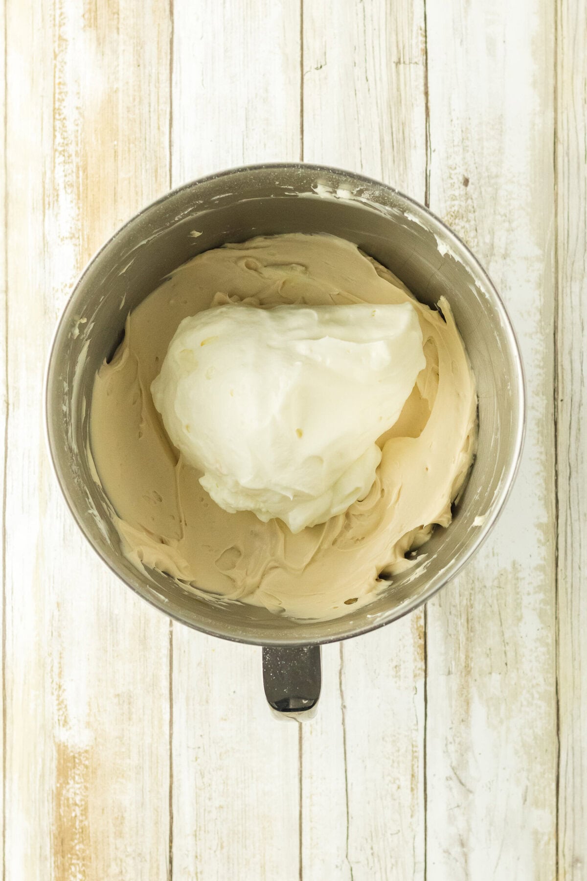 A mixing bowl with the creamy mixture inside.