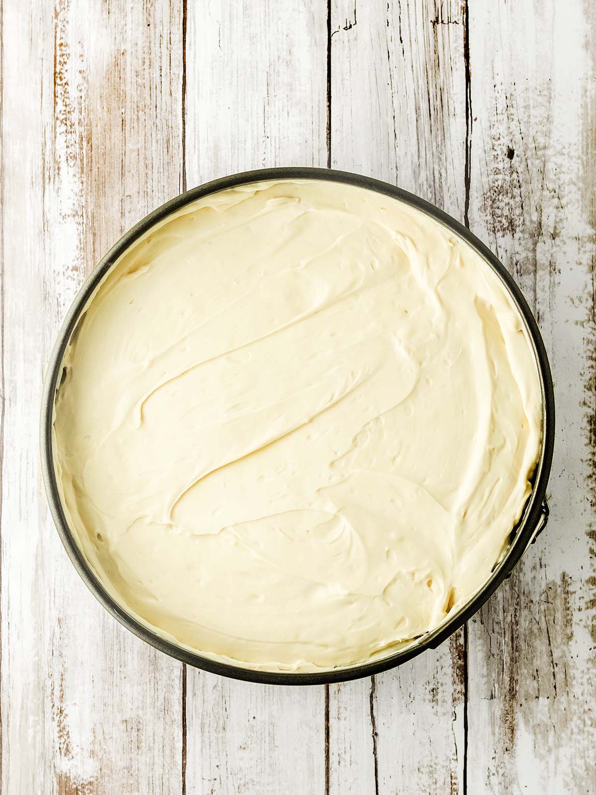 A cake mold with the creamy mixture inside.