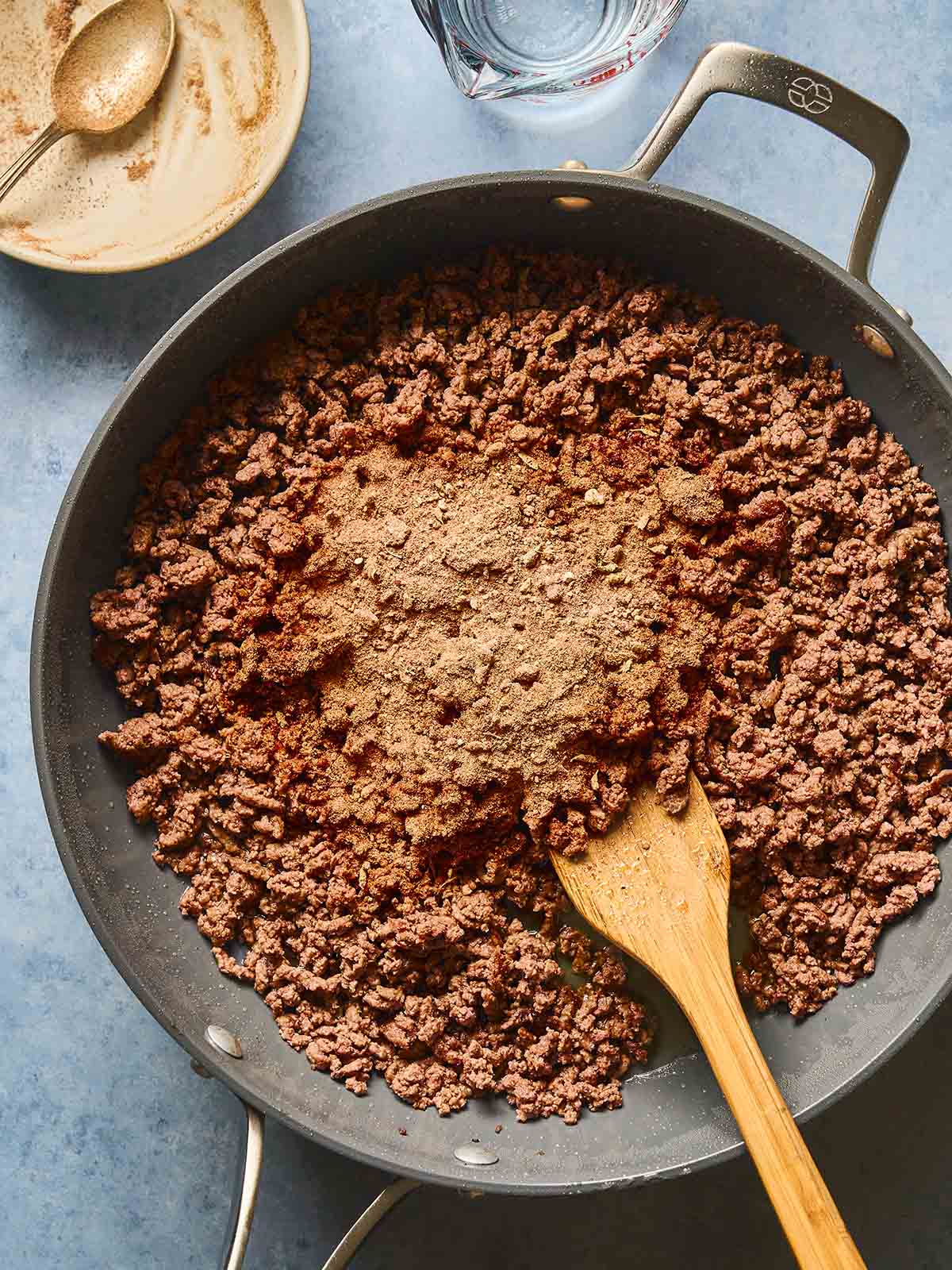 Cooking ground beef with the seasoning in a skillet.