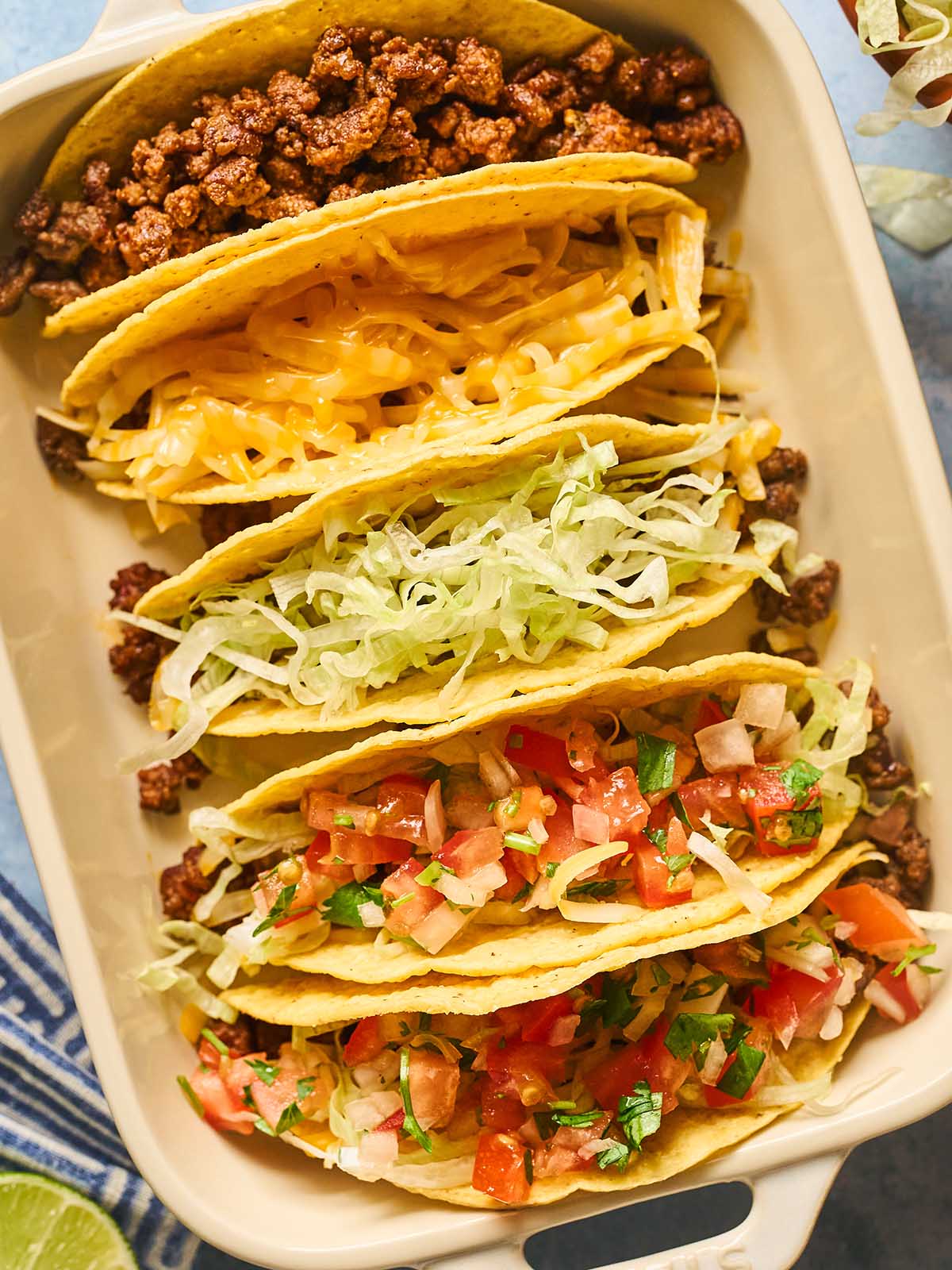 Building the hard shell tacos layer by layer.