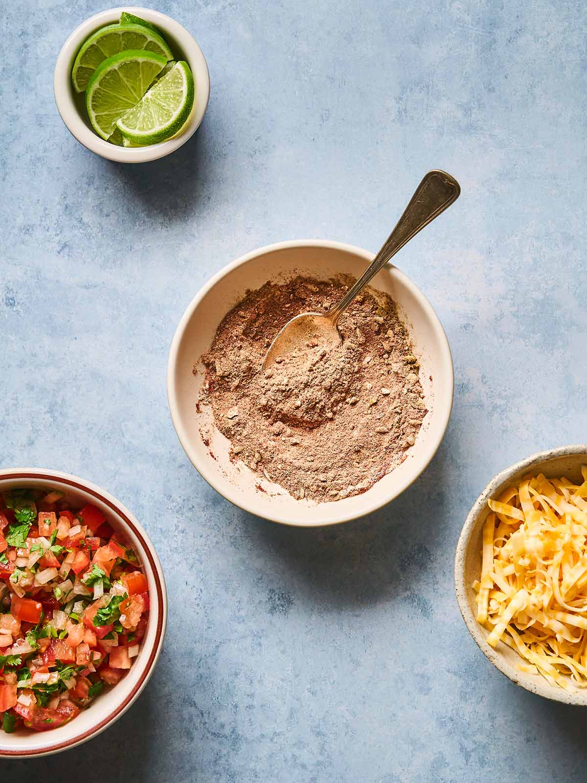 A bowl with taco seasoning and a spoon.