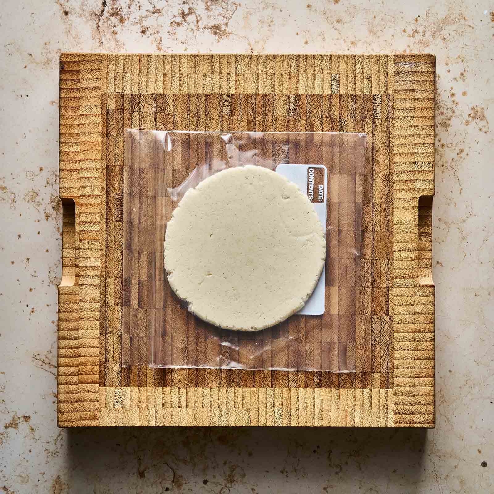 Freshly pressed tortilla inside plastic bag.