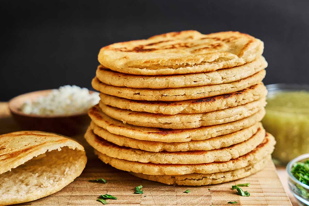 A stack of plain gorditas placed on top of a board.